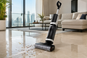 best-hard-floor-cleaners-uae-Modern UAE apartment living room with glossy marble tile flooring being cleaned using a cordless hard floor vacuum mop combo near a balcony window with visible city skyline.