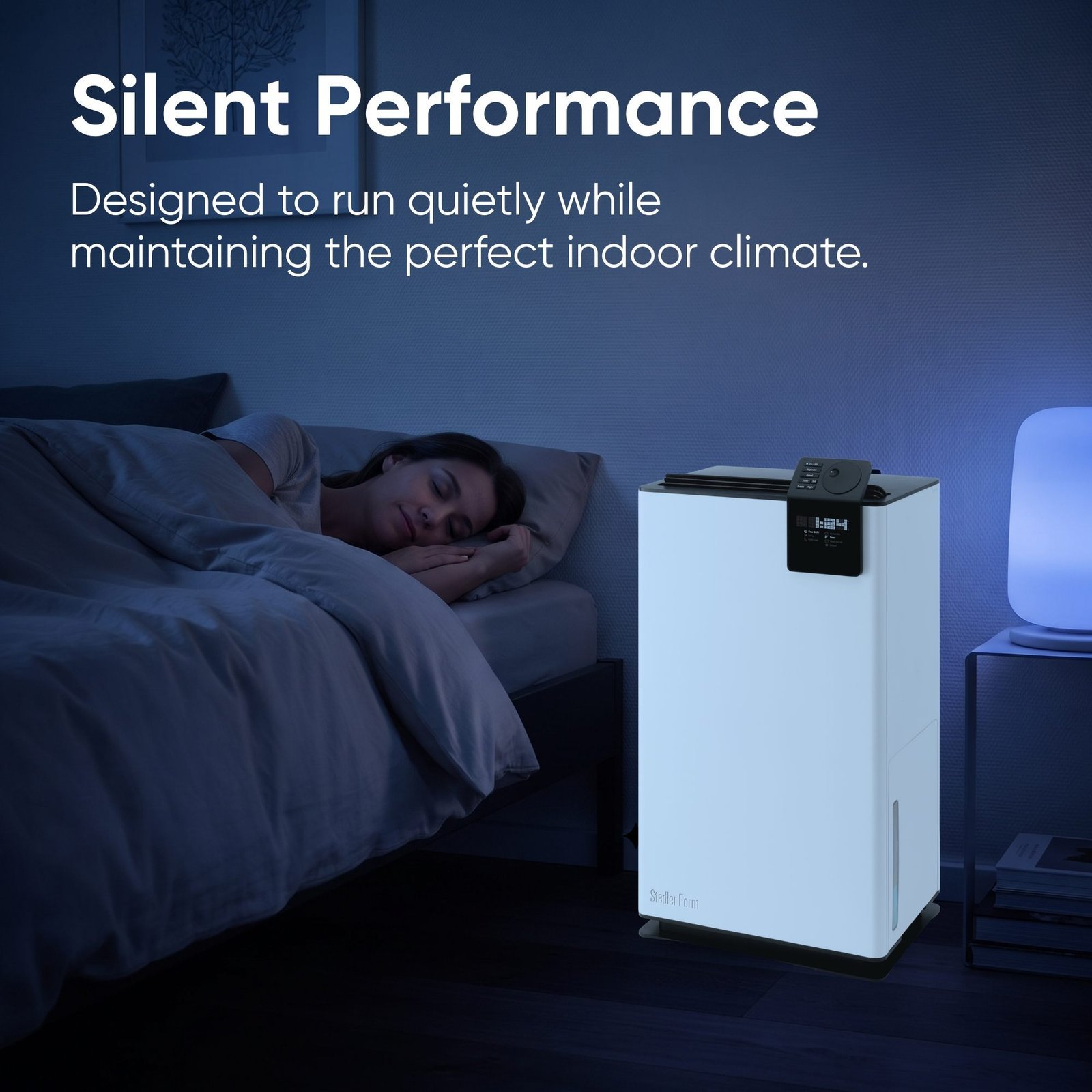 Stadler Form Albert dehumidifier running in night mode beside a bed
